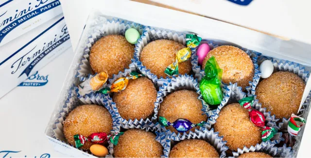 Gift box filled with assorted desserts and colorful candies.